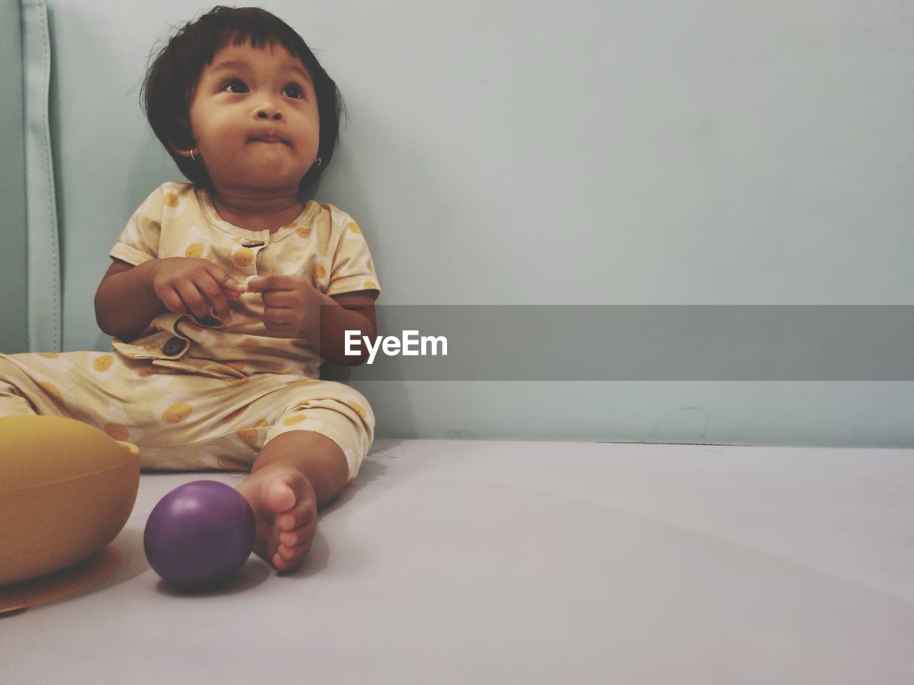 child, childhood, one person, baby, indoors, person, sitting, innocence, full length, cute, skin, copy space, portrait, front view, looking, baby clothing, babyhood, toddler, clothing, lifestyles, human face, emotion, looking away, casual clothing, domestic room