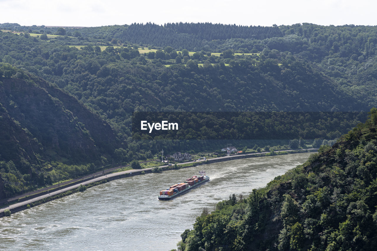 Loreley, germany - 25 july 2021. a large barge carrying a lot of containers on the rhine river 