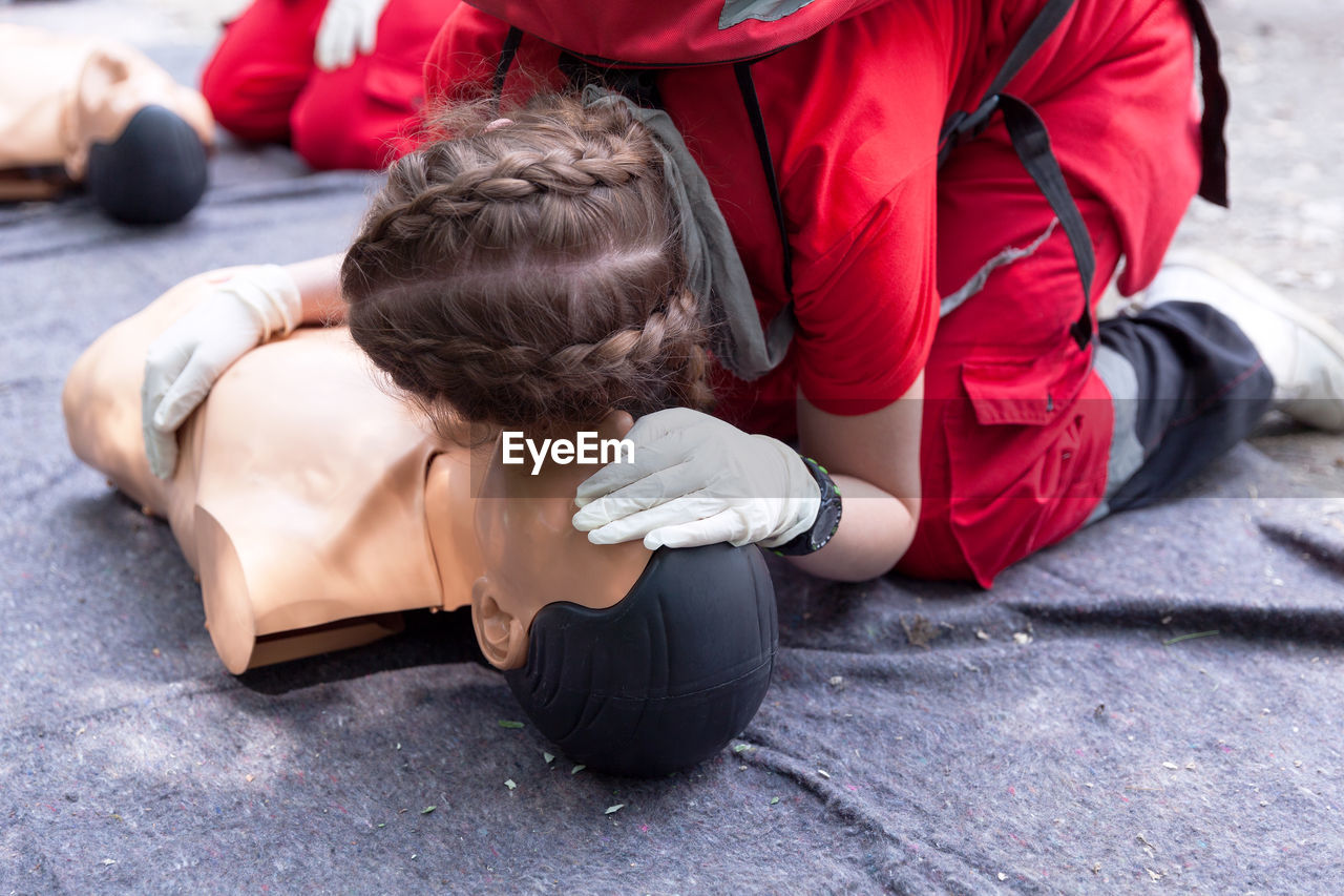 Low section of person performing cpr on dummy