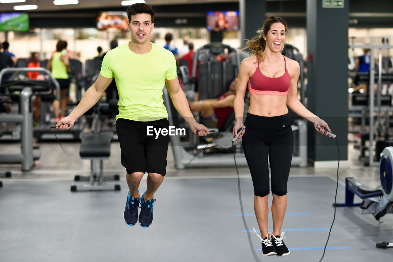 Friends exercising in gym