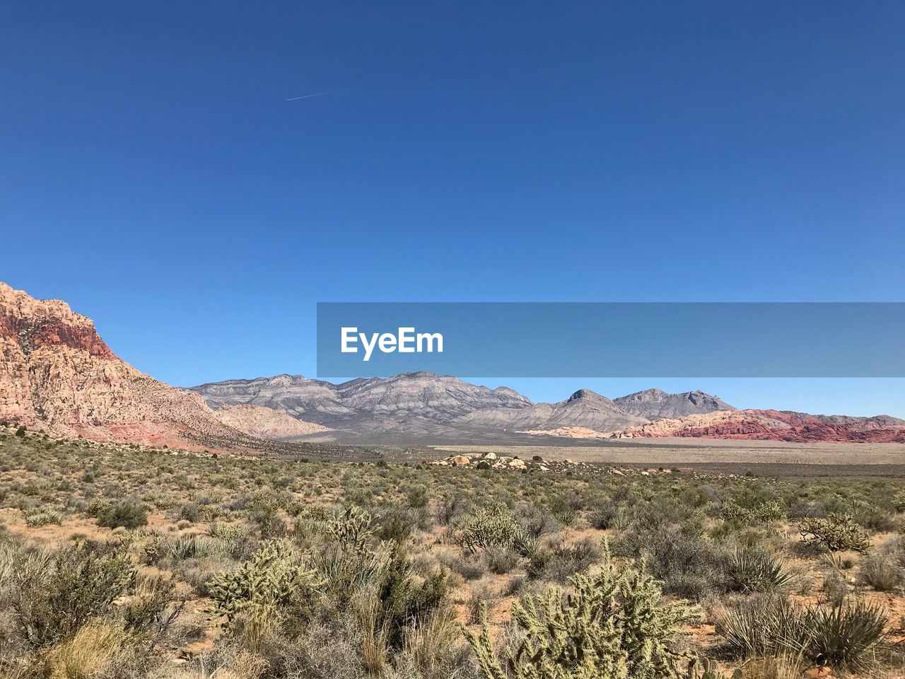 View of desert against blue sky