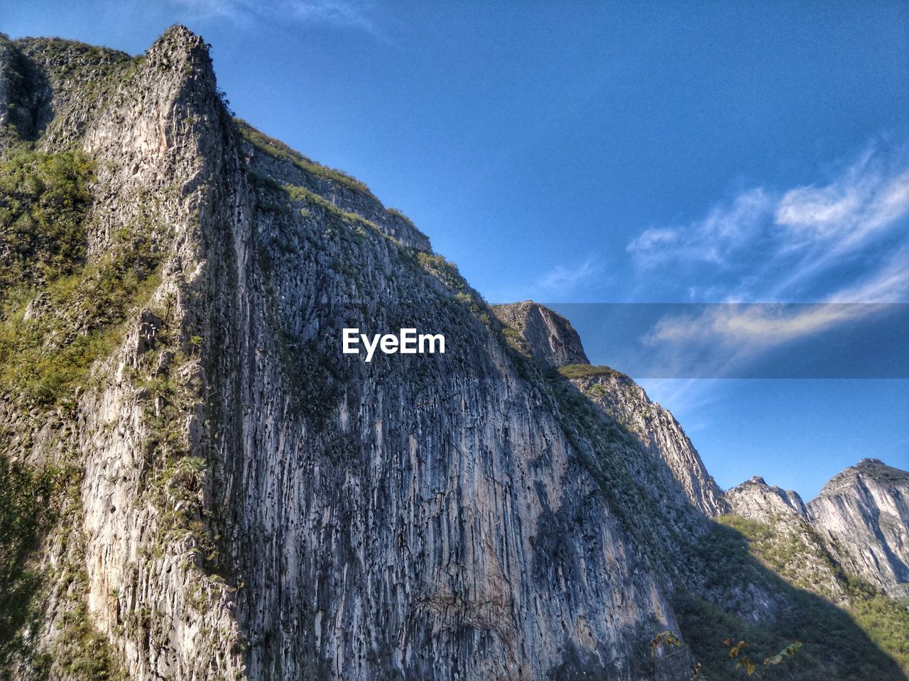 Low angle view of rock formations against sky