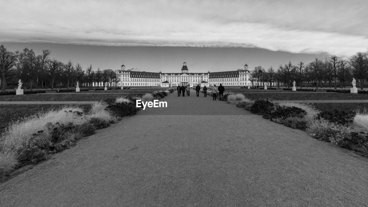 Street leading towards karlsruhe palace against sky