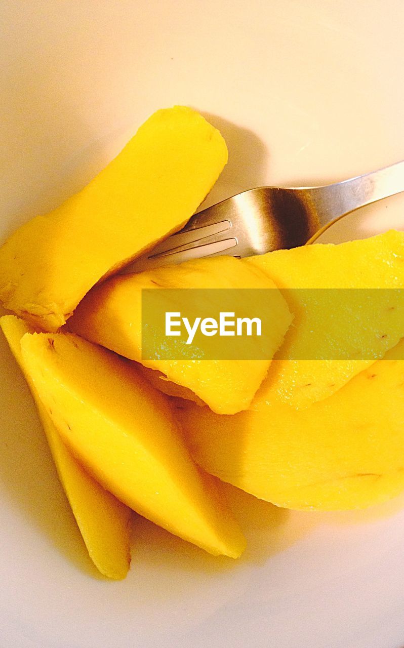 High angle view of mango slices in bowl