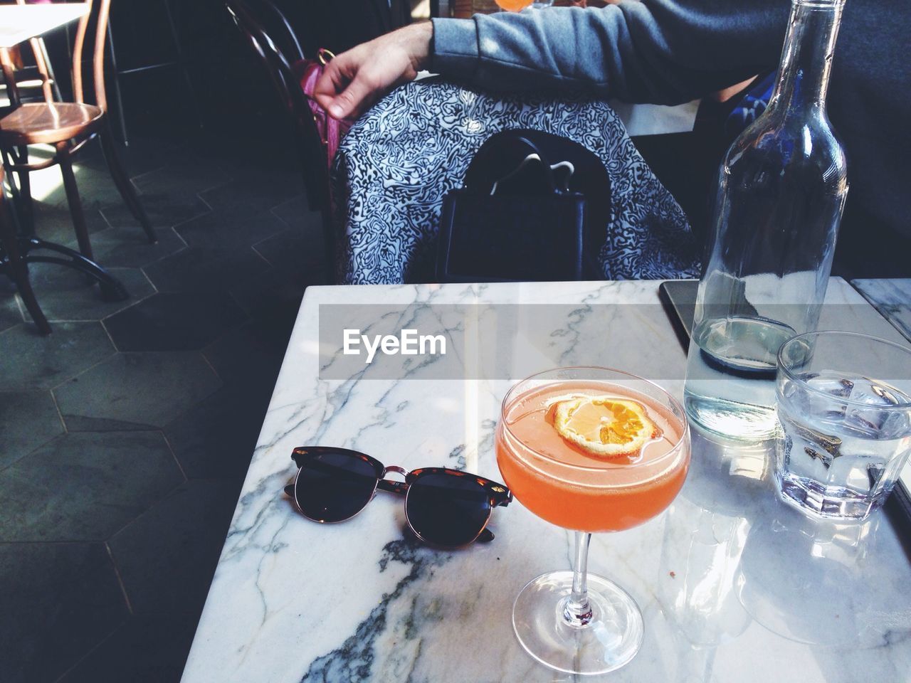 High angle view of cocktail with sunglasses on table