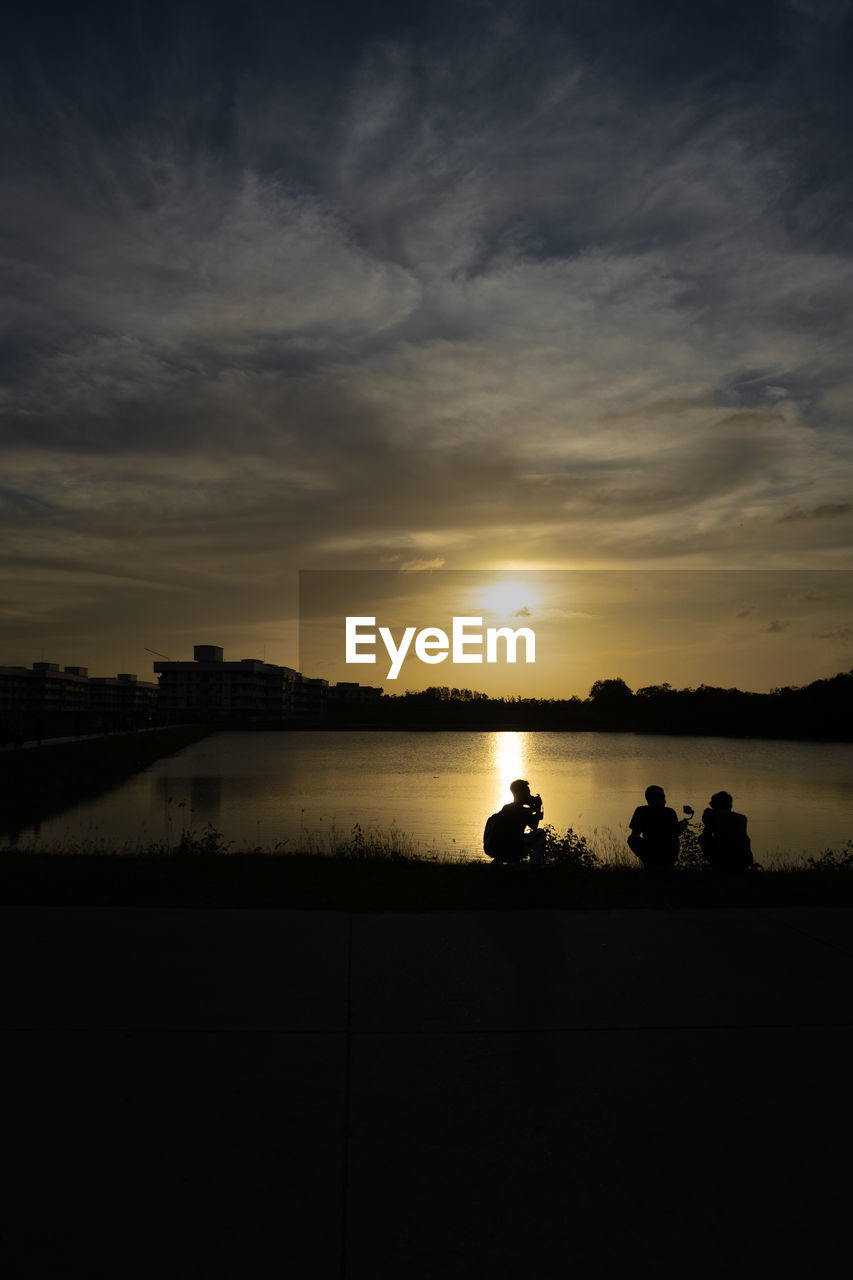 SCENIC VIEW OF LAKE AGAINST ORANGE SKY DURING SUNSET