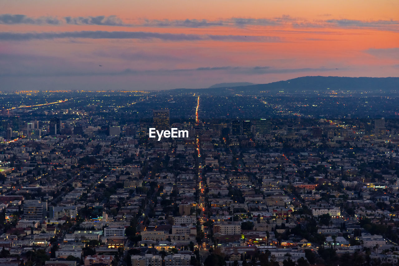 High angle view of city against sky during sunset