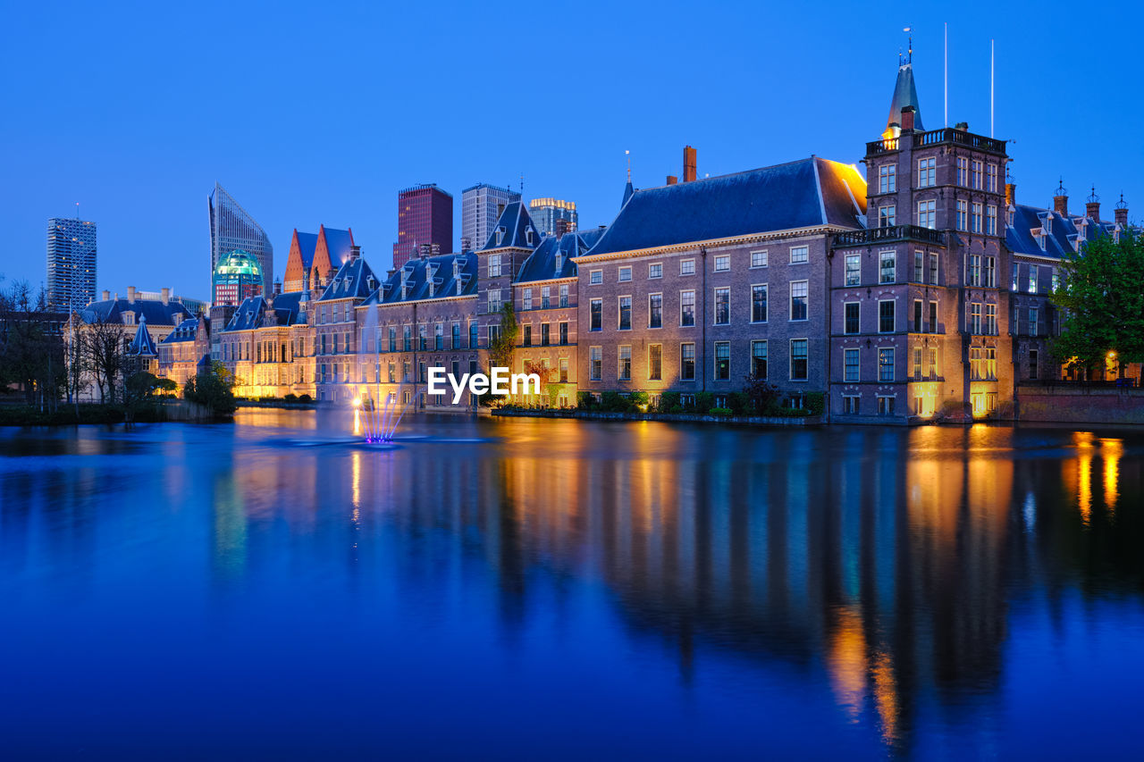 ILLUMINATED BUILDINGS AT WATERFRONT