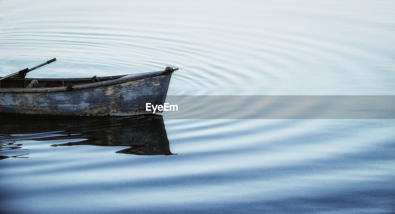 REFLECTION OF BOAT ON LAKE