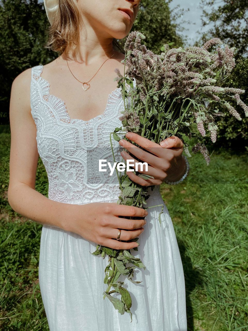 Midsection of woman holding plant