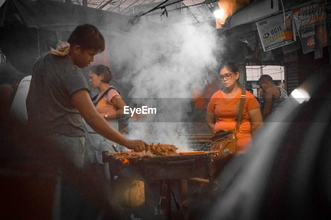 GROUP OF PEOPLE WORKING AT MARKET