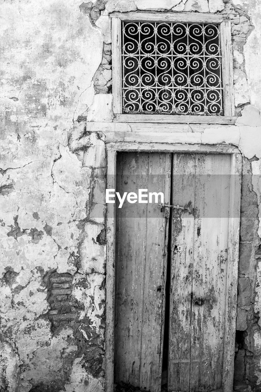 Closed wooden door of old house