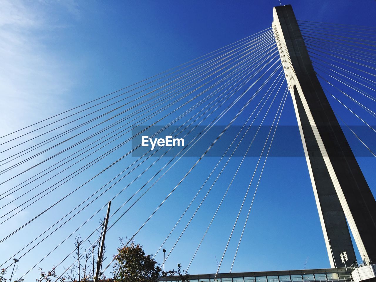 Low angle view of bridge against blue sky