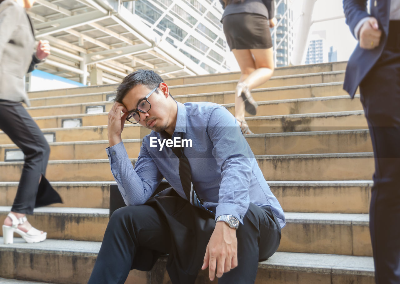 PEOPLE SITTING ON STAIRCASE