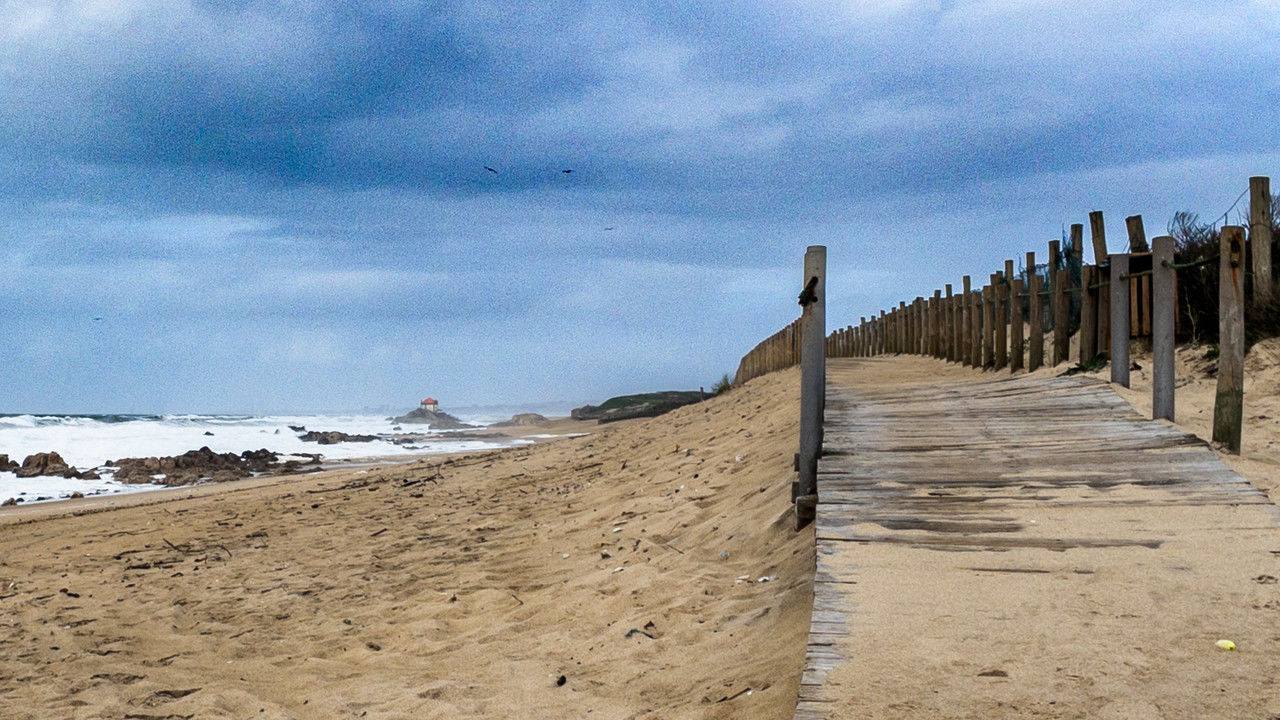 sky, beach, cloud, land, sea, sand, water, coast, nature, scenics - nature, shore, beauty in nature, tranquility, tranquil scene, day, walkway, no people, outdoors, boardwalk, the way forward, natural environment, architecture, wood, horizon, non-urban scene, landscape, travel destinations, environment, ocean, coastline, fence, horizon over water, holiday, built structure, footpath