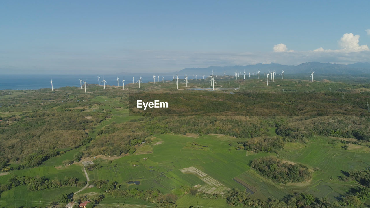 Aerial view of windmills for electric power production on the seashore. bangui windmills. solar farm