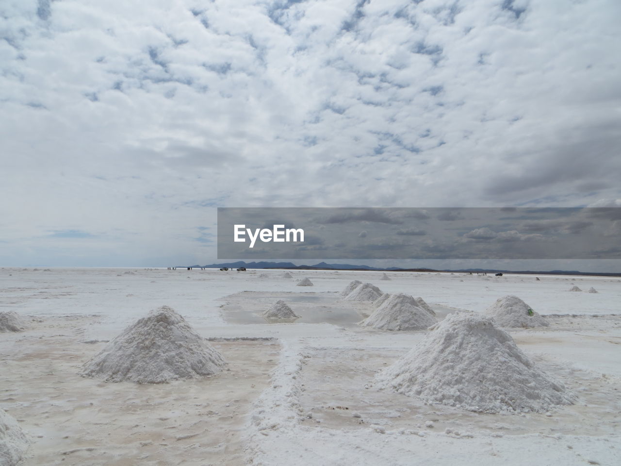 Heap of salt in salar de uyuni against sky