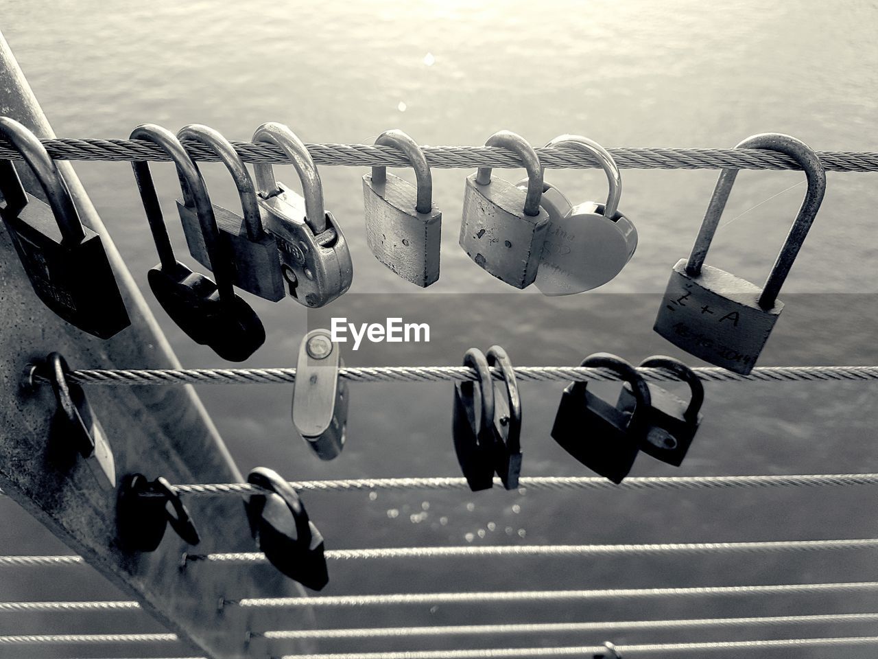 CLOSE-UP OF PADLOCKS HANGING ON RAILING