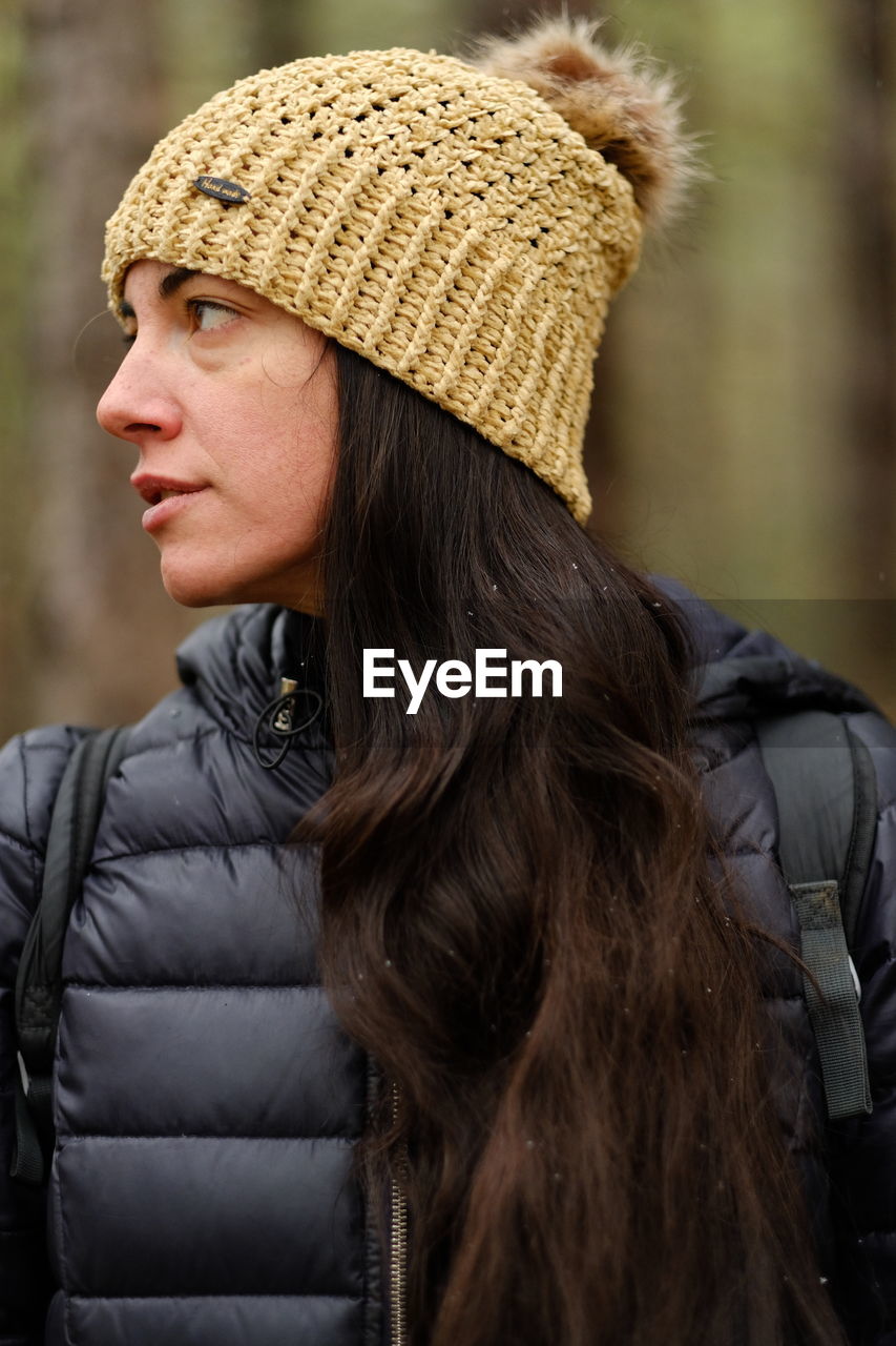 Rear view of woman wearing hat ib woods