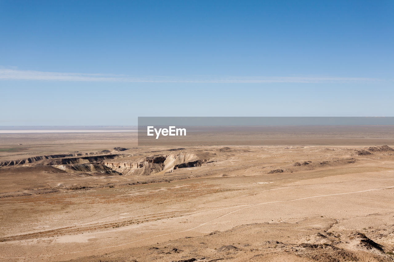 scenic view of desert against clear blue sky