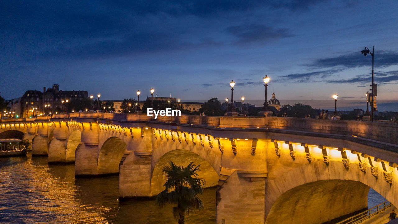 View of bridge over river at dusk