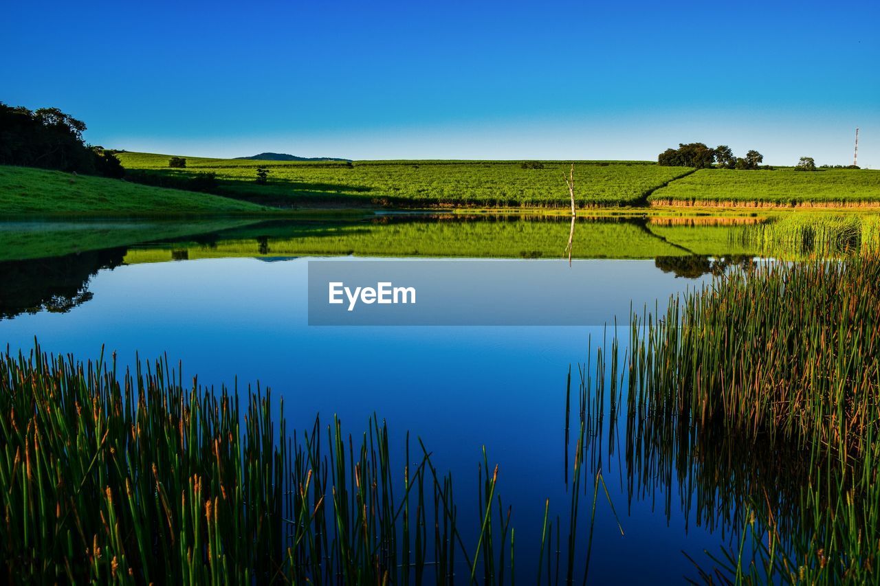 Calm lake along countryside landscape