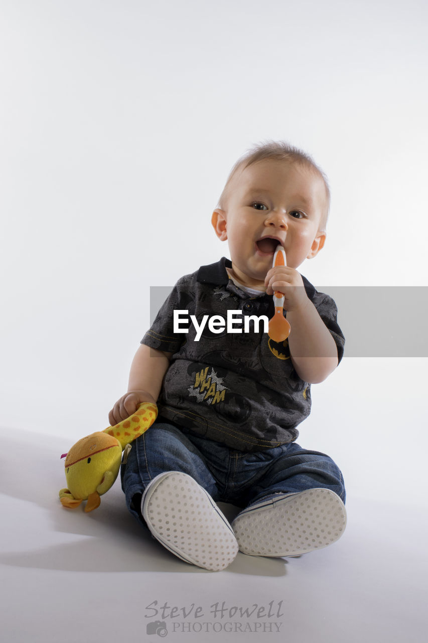 CUTE BABY GIRL SITTING ON FLOOR