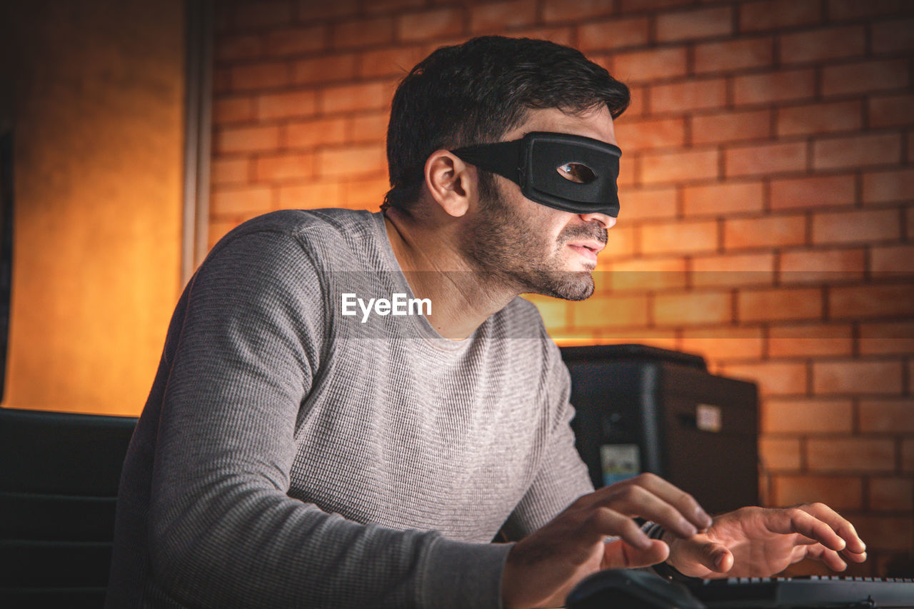 MAN WEARING SUNGLASSES ON WALL