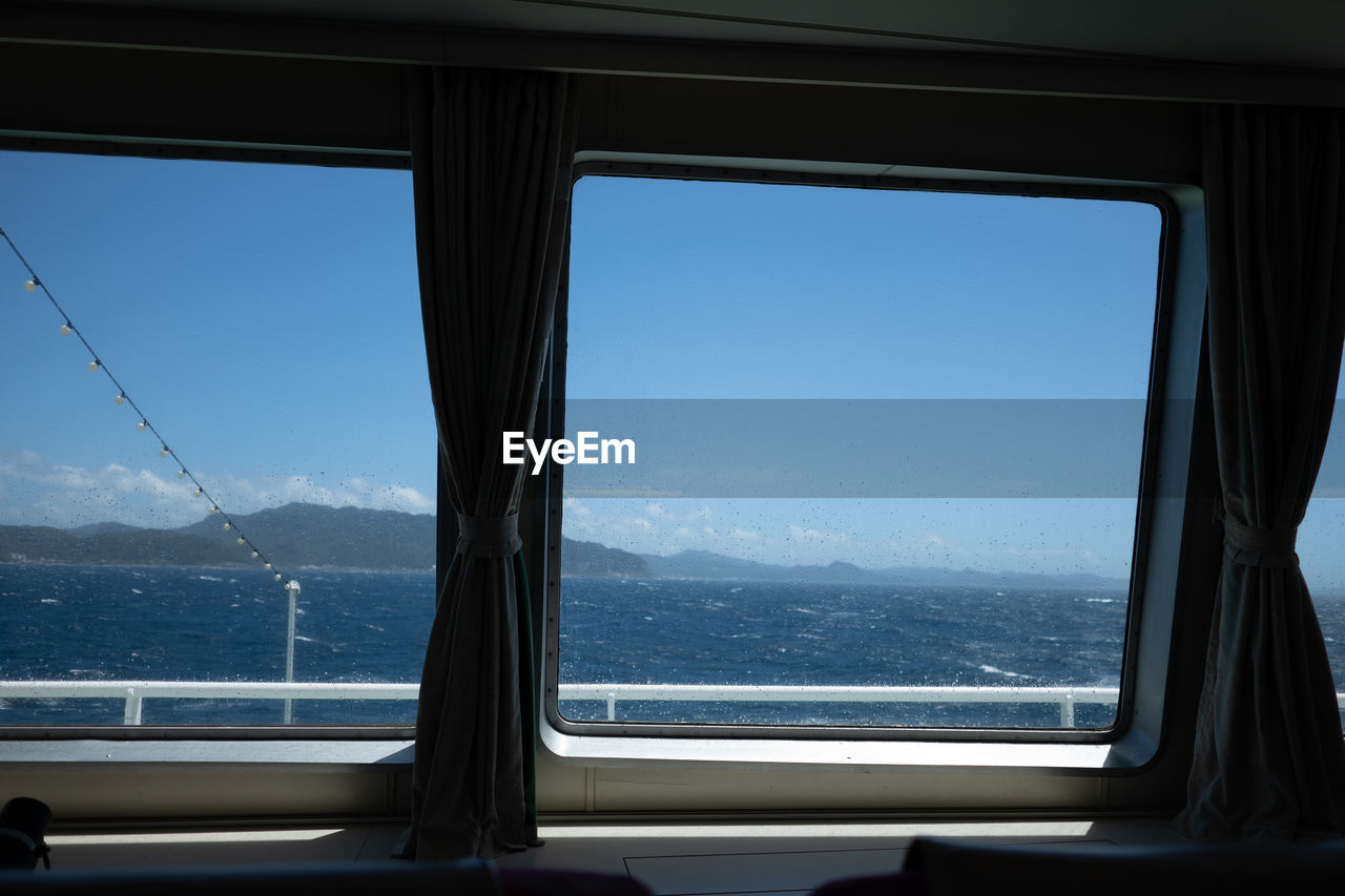 Scenic view of sea seen through window