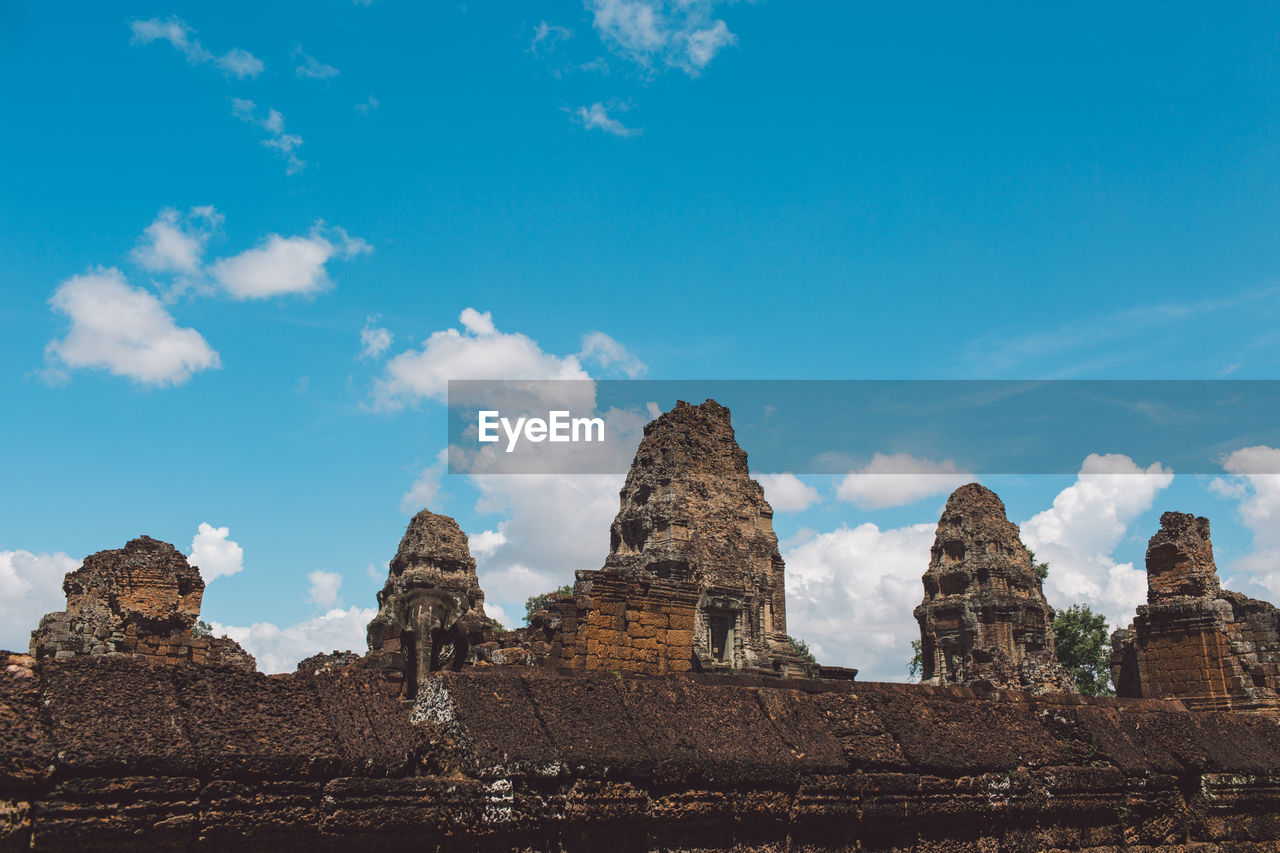 Low angle view of old temple against blue sky