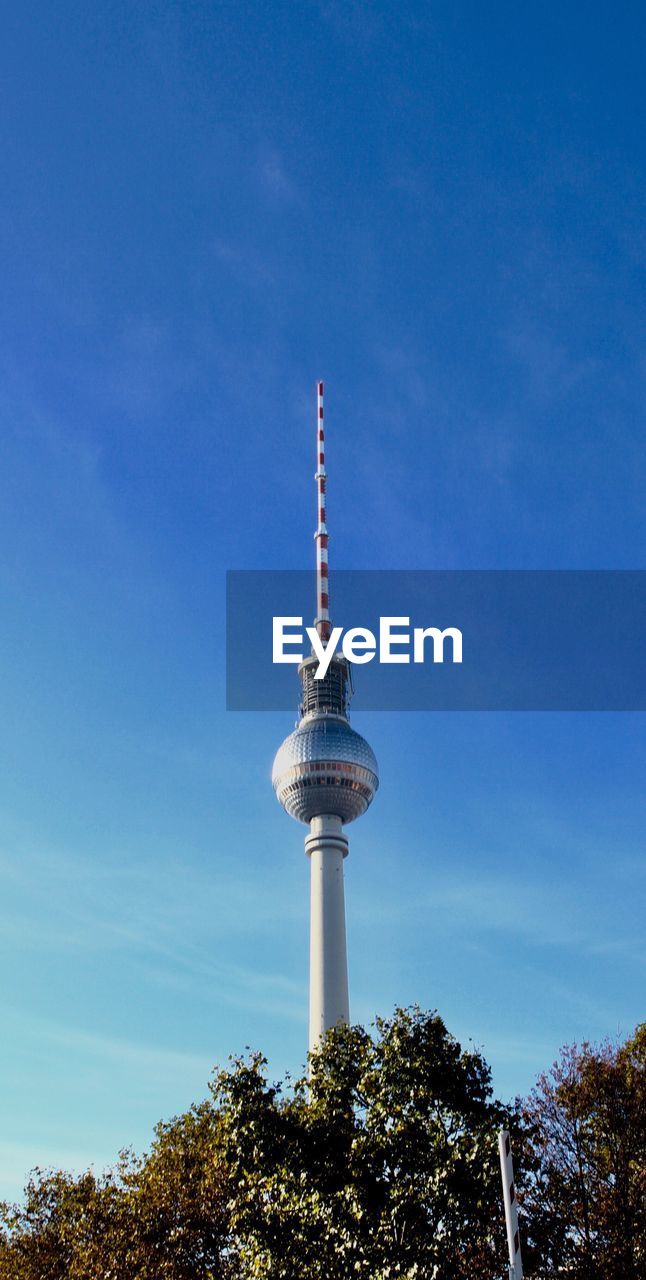 Low angle view of fernsehturm against blue sky