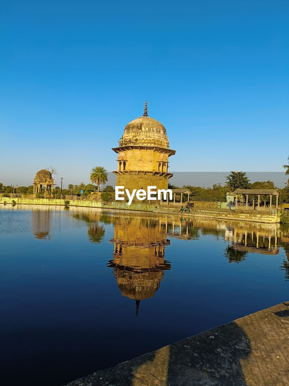 reflection, architecture, water, built structure, travel destinations, sky, building exterior, nature, blue, travel, history, religion, clear sky, the past, landmark, dome, city, lake, building, tourism, no people, belief, evening, dusk, outdoors, place of worship, sunny, day, temple - building, horizon, ancient, spirituality, tower