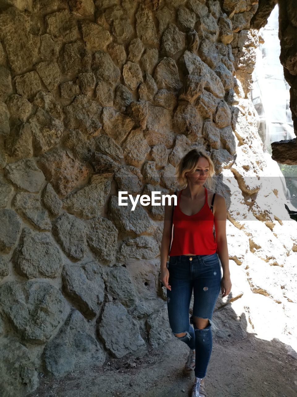 FULL LENGTH OF WOMAN STANDING ON ROCKS