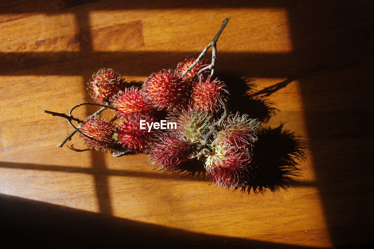 High angle view of lychees on wooden table