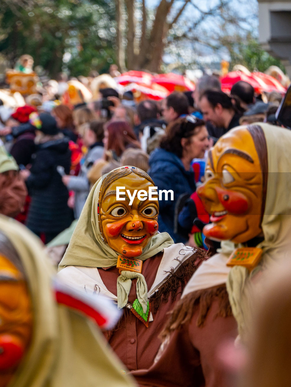 People wearing masks on road during parade