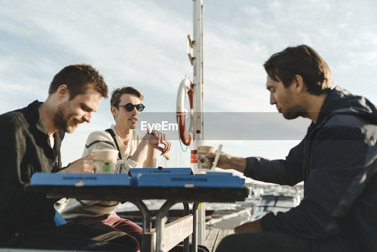 Men at marina having coffee