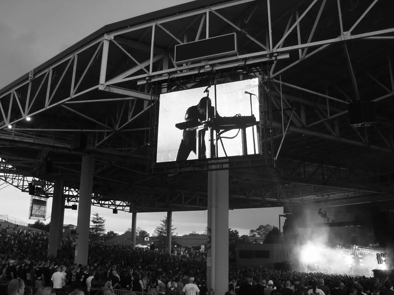 Low angle view of musician performing displayed on device screen at concert