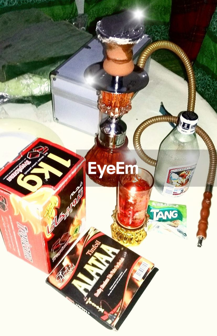 HIGH ANGLE VIEW OF VARIOUS BOTTLES ON TABLE AT HOME