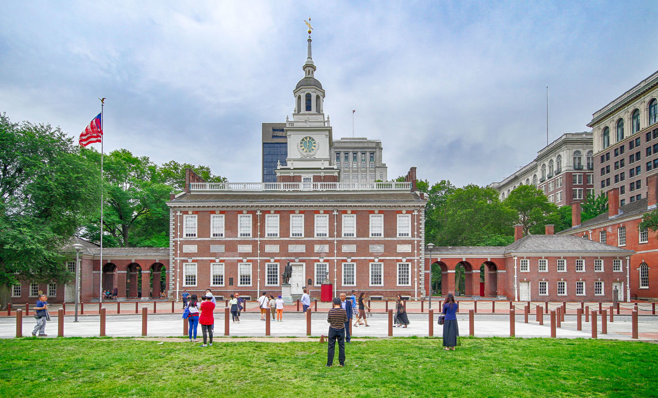 People in front of independence hall against sky