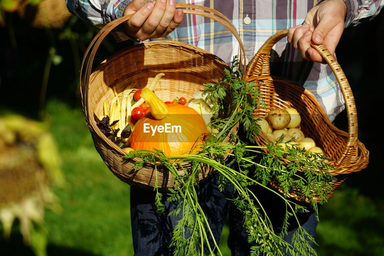 Midsection of man selling food in basket