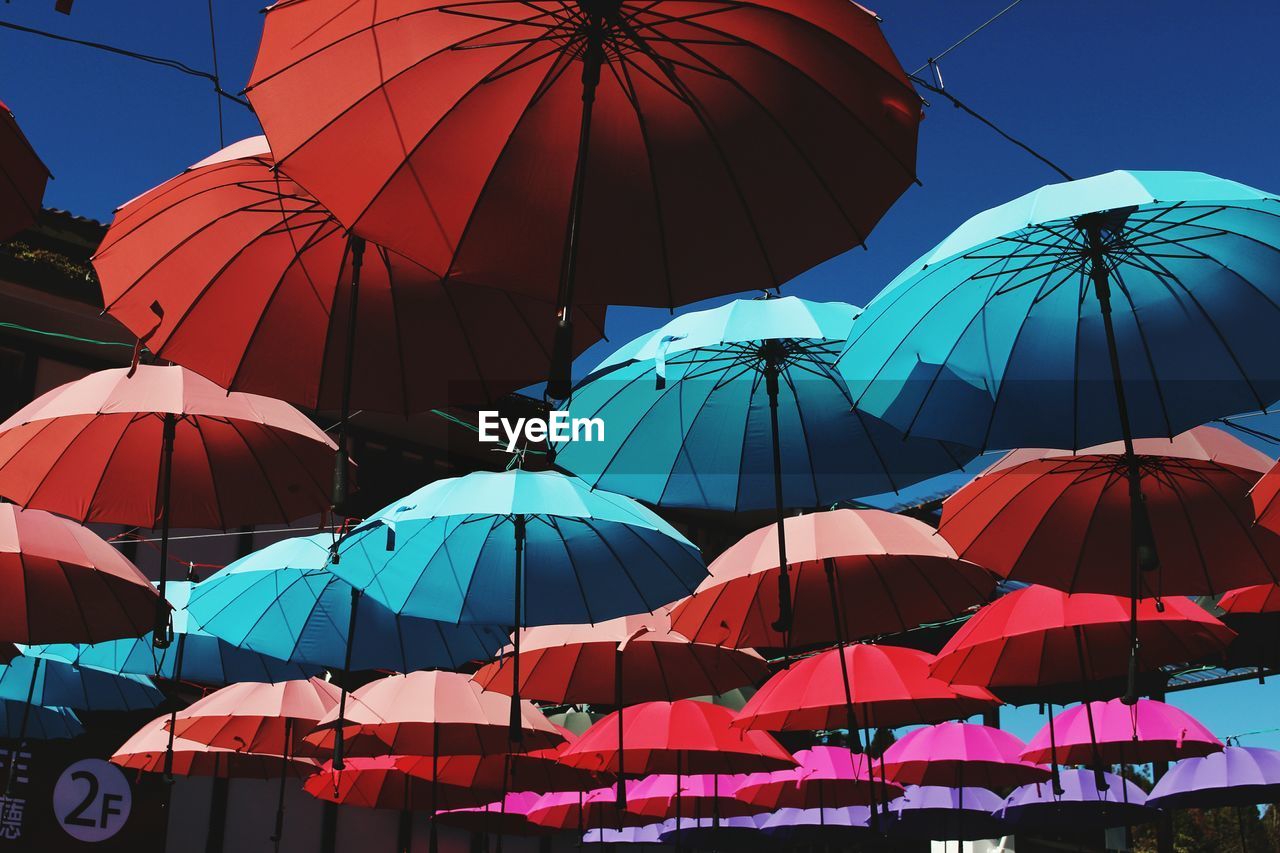 Multi colored umbrellas against clear sky