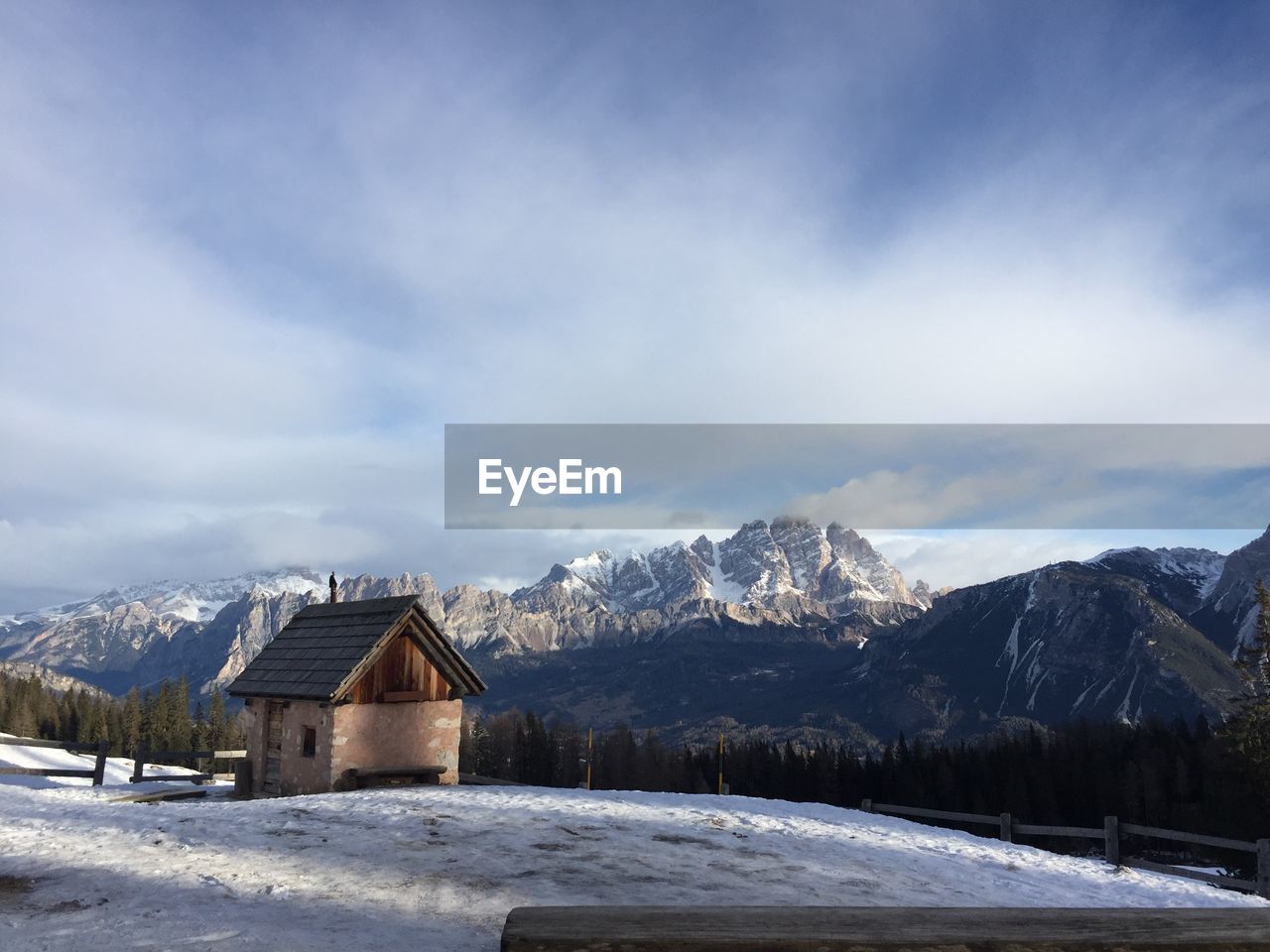 Houses on snowcapped mountain against sky