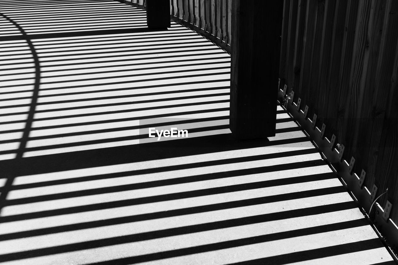 Shadow of railing on footbridge