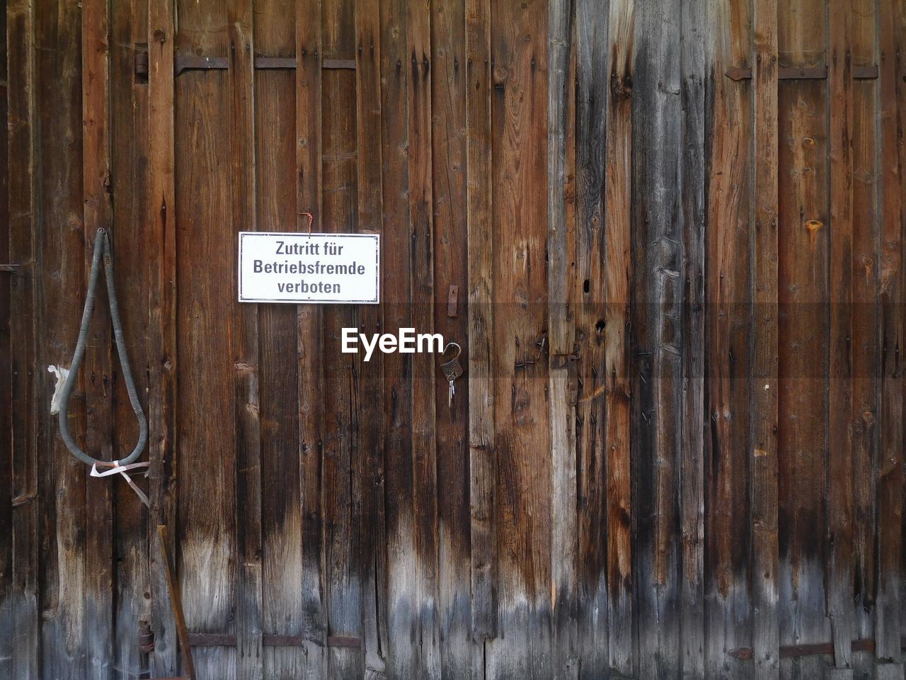 CLOSE-UP OF TEXT HANGING ON WOOD AT HOME