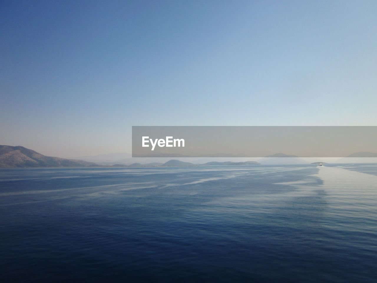 VIEW OF CALM BLUE SEA AGAINST THE SKY