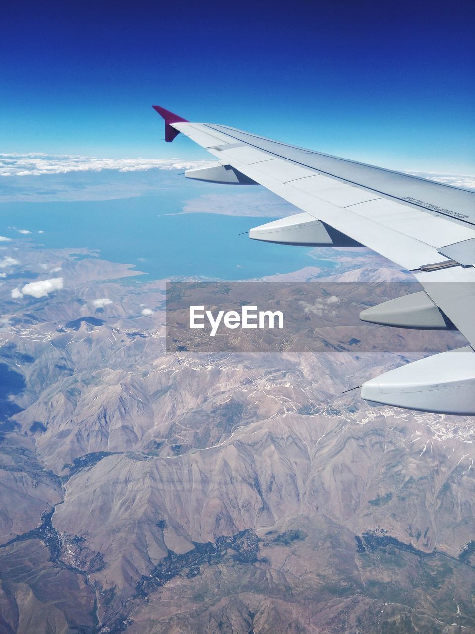 AERIAL VIEW OF AIRPLANE FLYING OVER LANDSCAPE