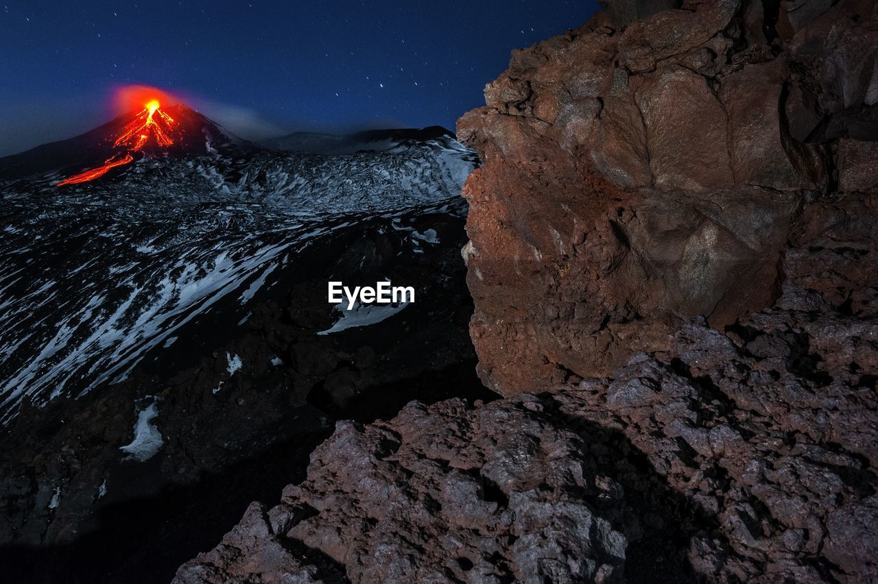 Rock formations against sky at night