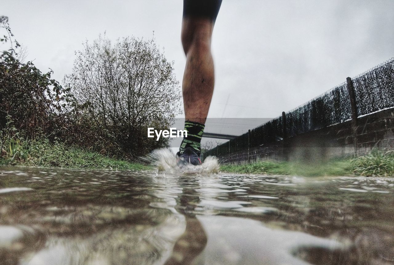 Low section of person running in water