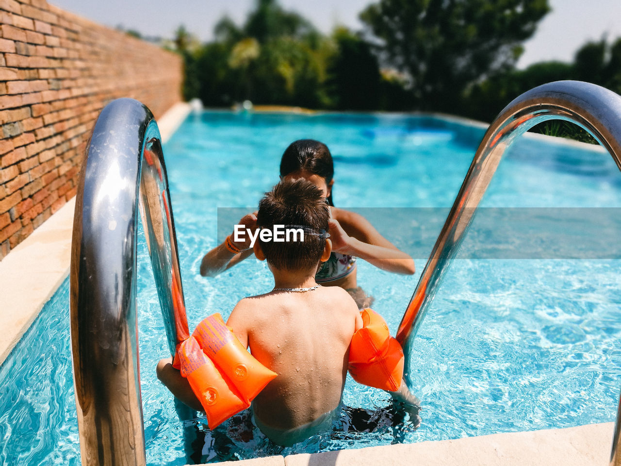 Boy and girl in swimming pool