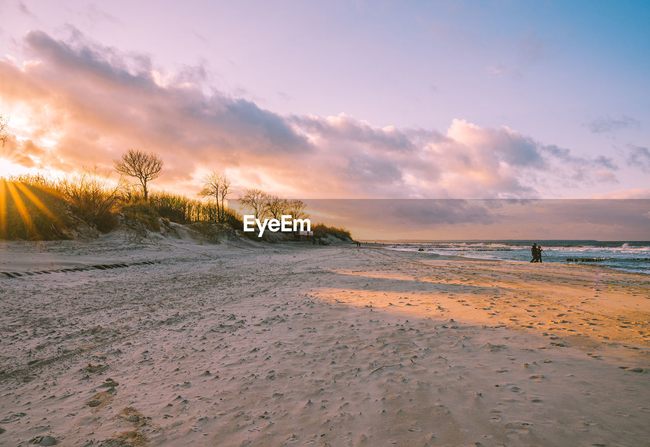 Scenic view of beach against sky during sunset